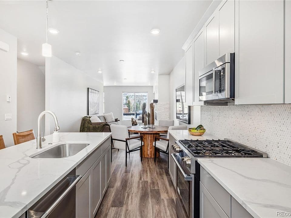 Modern kitchen with quartz counters and gas range