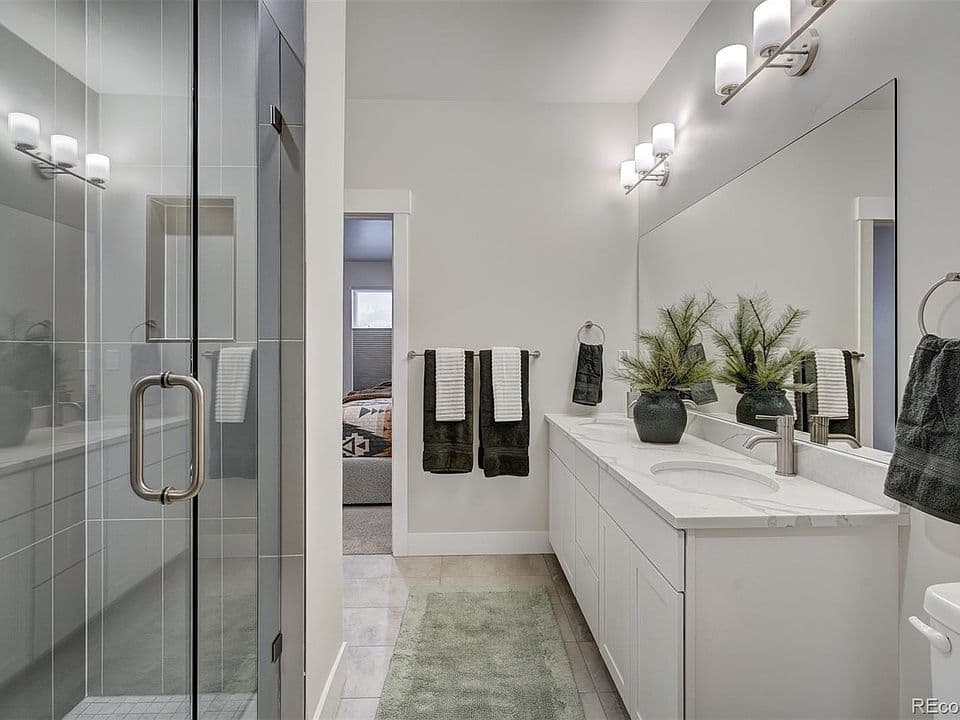Primary bathroom with double vanity and walk-in shower