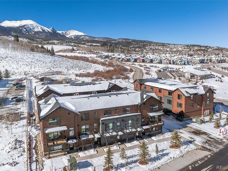 Property exterior in winter with snow-capped peaks